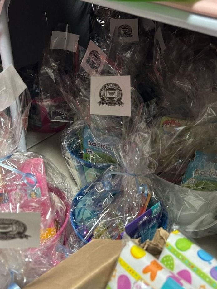 Wrapped Easter baskets tagged with United Against Crime logo labels are stacked together